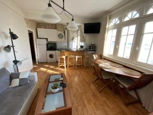 a living room with a couch and a table at L améthystes in Crozon +37 photos