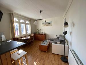 a living room with a couch and a table at L améthystes in Crozon