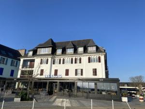 a large white building with a us homes sign on it at L améthystes in Crozon