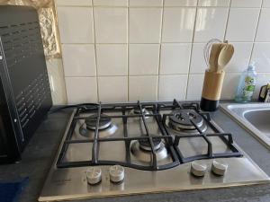 a stove top in a kitchen next to a sink at L améthystes in Crozon