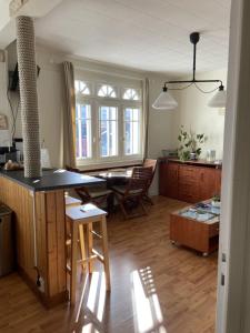 a kitchen and dining room with a table and chairs at L améthystes in Crozon