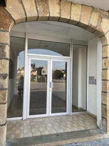 an entrance to a building with an open door at L améthystes in Crozon