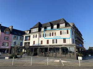 a large white building with a sign on it at L améthystes in Crozon