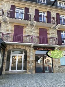 a brick building with balconies on the side of it at L améthystes in Crozon