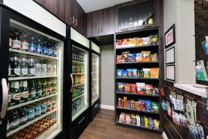 a grocery store aisle with two refrigerators at Residence Inn by Marriott Bakersfield West in Bakersfield