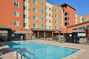 a large swimming pool in front of a building at Residence Inn by Marriott Bakersfield West in Bakersfield