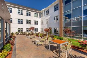 an empty courtyard of a building with tables and chairs at Element Chelmsford in Chelmsford