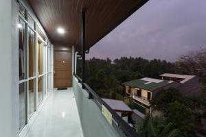 a balcony of a house with a view of the forest at Niwahas Apartments Kottawa in Pannipitiya