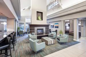 a lobby with chairs and a fireplace in a building at Residence Inn by Marriott Franklin Cool Springs in Franklin