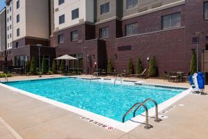 a swimming pool in front of a building at Residence Inn by Marriott Charlotte Northlake in Charlotte