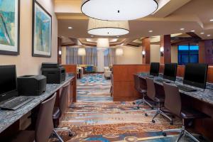 a conference room with a row of desks with computers at Fort Collins Marriott in Fort Collins