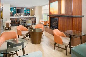 a lobby with tables and chairs and a fireplace at Residence Inn Seattle Bellevue Downtown in Bellevue