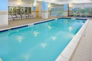 a large swimming pool with blue water in a building at Residence Inn Seattle Bellevue Downtown in Bellevue