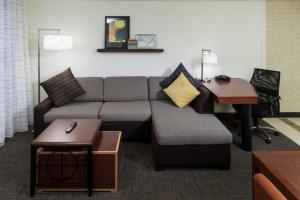 a living room with a couch and a desk at Residence Inn Boston Marlborough in Marlborough