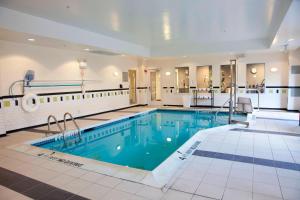 a large swimming pool in a hotel lobby at Fairfield Inn & Suites Bedford in Bedford