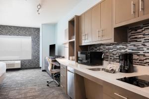 a kitchen with a sink and a microwave at TownePlace Suites Amarillo West/Medical Center in Amarillo