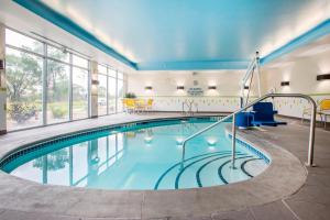 a pool in a hotel room with an indoor pool at Fairfield Inn & Suites by Marriott Waterloo Cedar Falls in Waterloo