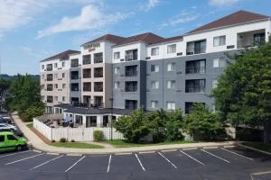 a large white building with a parking lot at Courtyard by Marriott Norwich in Norwich