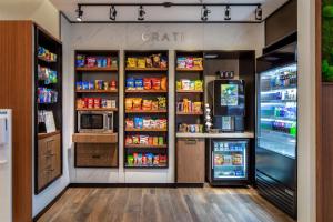 a store with an open refrigerator and lots of food at Courtyard by Marriott Conway in Conway