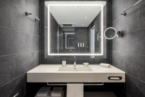 a bathroom with a sink and a mirror at Basel Marriott Hotel in Basel