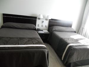 Postel nebo postele na pokoji v ubytování Hotel Diego de Almagro Chillan