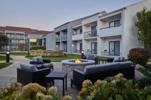 un patio con muebles y una hoguera frente a un edificio en Courtyard Chicago Oakbrook Terrace, en Oakbrook Terrace