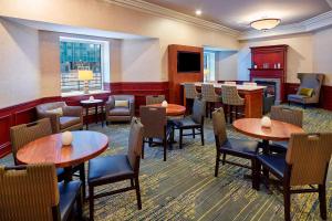 a restaurant with tables and chairs and a bar at Residence Inn Milwaukee Downtown in Milwaukee