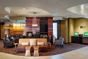 a lobby of a hotel with a couch and chairs at Courtyard Richland Columbia Point in Richland