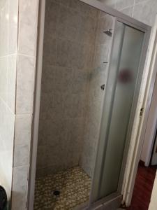 a shower with a glass door in a bathroom at Gilgal Abode in Secunda