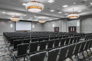 a lecture hall with chairs and a white screen at Courtyard Des Moines Ankeny in Ankeny