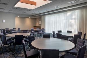 a room with tables and chairs and a large window at Courtyard By Marriott Baltimore Hunt Valley in Hunt Valley
