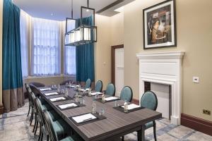 a conference room with a long table and chairs at The Dixon, Tower Bridge, Autograph Collection in London