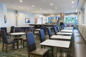 a dining room with tables and chairs and a cafeteria at Residence Inn by Marriott Houston West/Beltway 8 at Clay Road in Houston