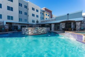 a large swimming pool in front of a hotel at Residence Inn by Marriott Houston West/Beltway 8 at Clay Road in Houston