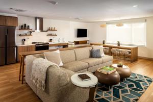 a living room with a couch and a kitchen at Element Bend in Bend