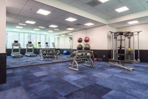 a gym with several tread machines in a room at SpringHill Suites by Marriott Charlotte City Center in Charlotte