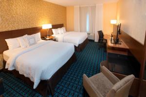 a hotel room with two beds and a desk at Fairfield Inn & Suites by Marriott Detroit Lakes in Detroit Lakes