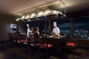 a group of people in a kitchen with a chef at Courtyard by Marriott Shin-Osaka Station in Osaka