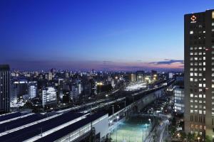 a view of a city at night with buildings at Courtyard by Marriott Shin-Osaka Station in Osaka