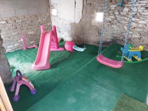 a room with swings and toys on the floor at Feriënhaus Hohe Acht in Siebenbach