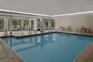 a large pool with blue water in a hotel at Courtyard Detroit Brighton in Brighton