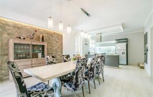 a kitchen and dining room with a table and chairs at Villa Cristina in Montemagno