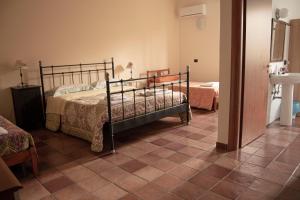 a bedroom with two beds and a tile floor at A Nespulara in Galati Marina