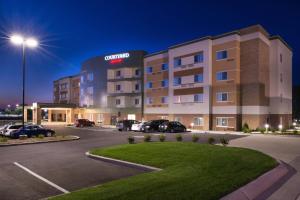 a hotel with cars parked in a parking lot at Courtyard by Marriott St. Louis St. Peters in Saint Peters