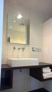 a bathroom with a sink and a mirror at Studio@Domburg in Domburg