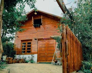 a wooden cabin with a large wooden door at Simplewoods Homestay in Da Lat in Da Lat