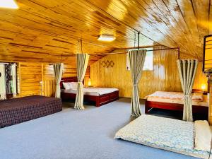 a bedroom with two beds in a wooden cabin at Simplewoods Homestay in Da Lat in Da Lat +58 photos