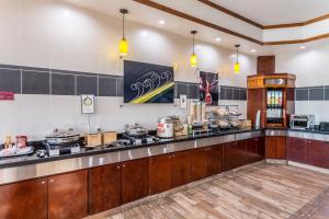 a large kitchen with a counter with a stove at Fairfield Inn & Suites by Marriott Alamogordo in Alamogordo
