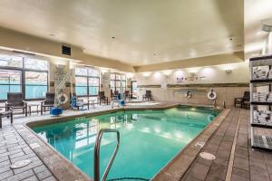 a pool in a hotel with chairs and tables at Fairfield Inn & Suites by Marriott Alamogordo in Alamogordo