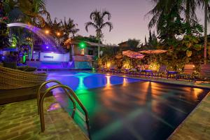 a swimming pool at a resort at night at Hotel Pousada Natural in Brotas